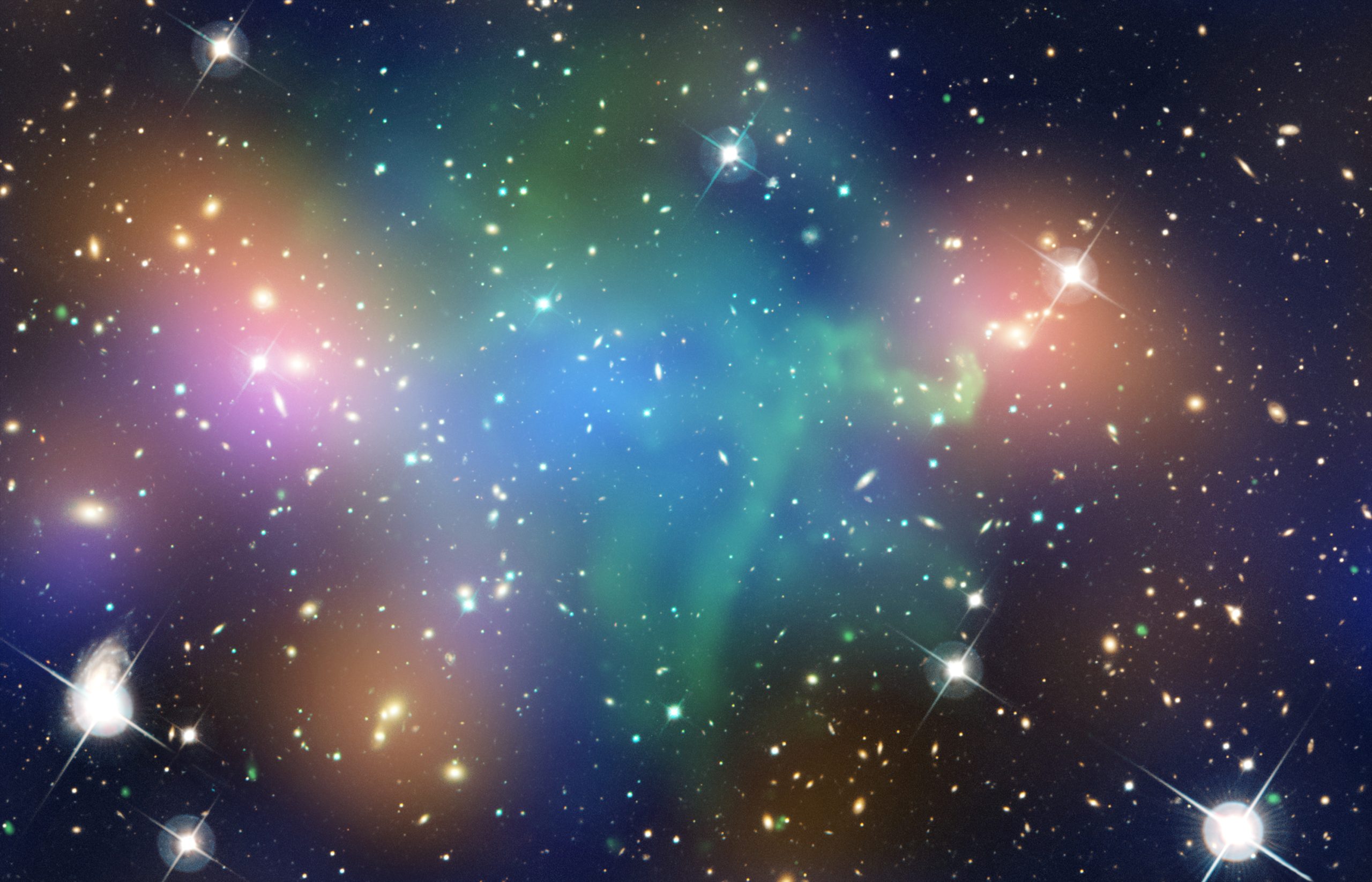 A collision of massive galaxy clusters located about 2.4 billion light years from Earth. This composite image shows the distribution of dark matter, galaxies, and hot gas in the core of the merging galaxy cluster Abell 520. Data from Chandra (green) show the hot gas in the clusters and provides evidence that a collision took place. Optical data from Hubble and the Canada-France-Hawaii Telescope in Hawaii are shown in red, green, and blue. Starlight from galaxies within the clusters, which has been smoothed to show the location of most of the galaxies, is colored orange. Confirming a previous observation, this result reveals that a clump of dark matter resides near most of the hot gas, where very few galaxies are found.